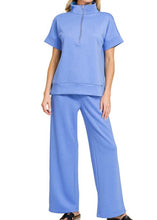 Load image into Gallery viewer, Woman wearing a blue outfit with a short-sleeve top and wide-leg pants on a white background