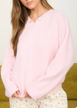 Load image into Gallery viewer, lightweight button down kit cardigan pink with white background with green couch in the back