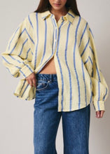 Load image into Gallery viewer, Person wearing a yellow and blue striped shirt with blue jeans on a plain background