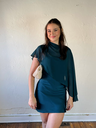 LE LIS satin slip dress with a cape overlay, featuring a smooth, elegant design and delicate fabric for a stylish look.