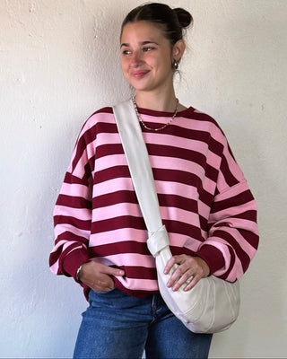 Urban Expressions Crescent City crossbody bag with adjustable strap and stylish design, featuring a zip closure and front pocket.