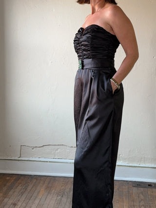 Black strapless satin wide-leg jumpsuit from Flying Tomato, shown on a model with flowing fabric and elegant style.
