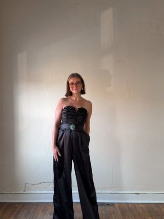 Black strapless satin wide-leg jumpsuit by FLYING TOMATO, featuring a sleek design and elegant fit.