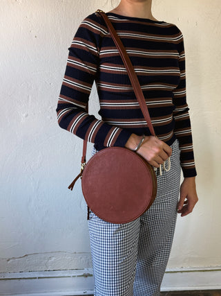 OSGOODE MARLEY Sawyer Circle Crossbody bag with round shape, adjustable strap, and stylish design.