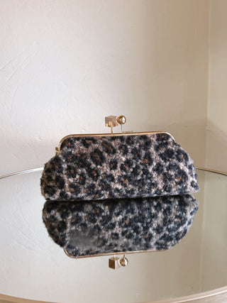 Urban Expressions Aurelia Leopard Boucle clutch bag with leopard print and textured fabric, stylish accessory for evening or casual outfits.