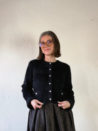 Black fuzzy pearl button cropped cardigan by Flying Tomato, showing the textured knit fabric and pearl button details.