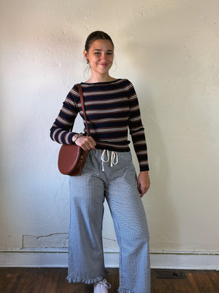 Navy stripe boat neck pullover by THE WORKSHOP STUDIO, featuring a relaxed fit and classic design, on a hanger.