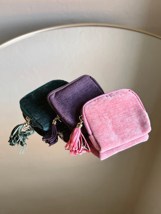 Velvet tassel jewelry travel pouch in dusty teal with a gift tag, designed for organizing jewelry on the go.