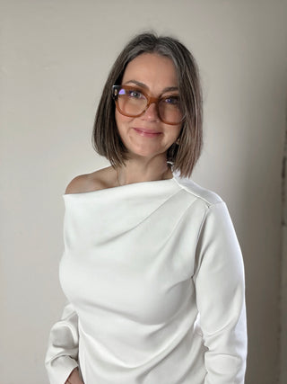 Cream asymmetrical knit top by STEVIE JANE featuring a contour drape and stylish design, ideal for casual or chic outfits.