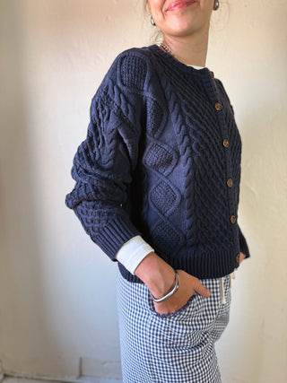 Buttermelon Heritage Cable Knit Cardigan featuring a cozy cable-knit design in neutral tones, perfect for casual wear.
