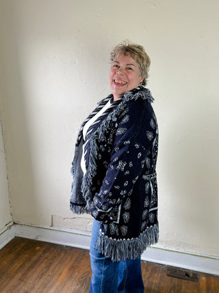 MABLE Bandana Fringe Longline Cardigan draped over a mannequin, showing its longline silhouette and detailed fringe accents.