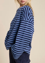 Load image into Gallery viewer, Person wearing a blue and black striped sweater on a beige background
