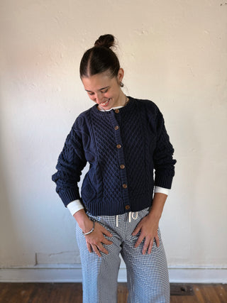 Buttermelon Heritage Cable Knit Cardigan, cozy cable-knit sweater with a classic design, shown in natural beige color.