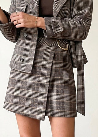 SKIES ARE BLUE Cambridge plaid hardware mini skirt featuring a stylish plaid pattern and hardware details on a model.