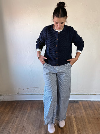 Buttermelon Heritage Cable Knit Cardigan in cozy, textured knit with a classic button-up design and ribbed cuffs.