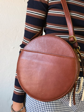 OSGOODE MARLEY Sawyer Circle Crossbody bag in black leather with adjustable strap and circular design, stylish and practical accessory.