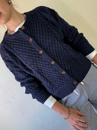 Buttermelon heritage cable knit cardigan with a classic knit pattern, featuring a cozy, textured cable design in soft yarn.
