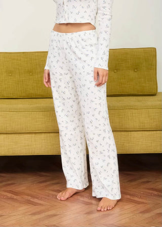 Floral Pointelle Knit Lounge pants with a green couch and white background