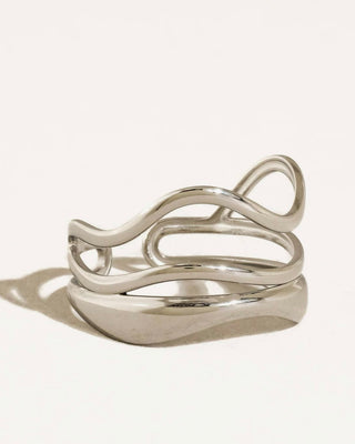 Silver abstract ring from Flânerie by Maiq, featuring a modern, artistic design with textured silver band.