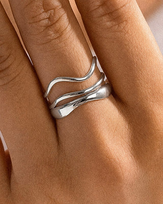 Silver abstract ring from FLÂNERIE BY MAIQ's Sloane collection, featuring modern, artistic design on a neutral background.