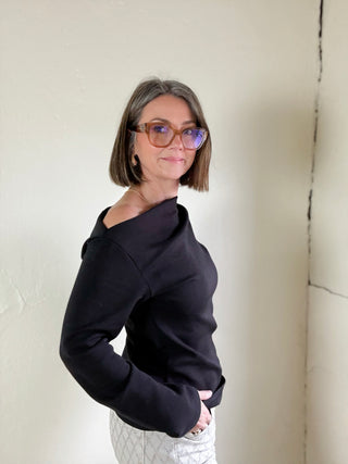 Black asymmetrical knit top by STEVIE JANE, Contour Drape LSKT, featuring a stylish draped design and modern silhouette.