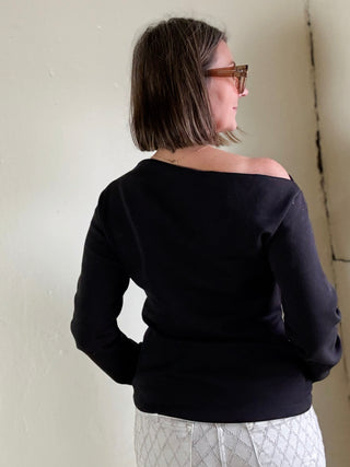 Black asymmetrical knit top from Stevie Jane's Contour Drape LSKT collection, displayed on a neutral background.