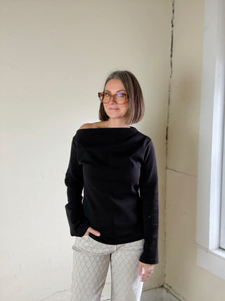 Black asymmetrical knit top from Stevie Jane's Contour Drape LSKT collection, featuring a stylish, draped design.
