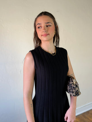 She + Sky DMIN sleeveless flare sweater dress in a cozy knit fabric, featuring a fitted bodice and flowing skirt.