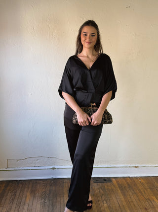 Black satin kimono sleeve jumpsuit by Sunday Edition by Le Lis, featuring a relaxed fit and elegant design.