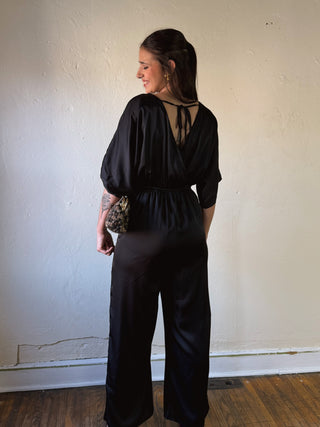 Black satin kimono sleeve jumpsuit by Sunday Edition by Le Lis, featuring a stylish, flowing design and elegant silhouette.
