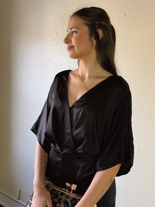 Black satin kimono sleeve jumpsuit by SUNDAY EDITION BY LE LIS, featuring a sleek, elegant design with wide kimono sleeves.