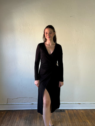 Black surplice wrap long sleeve midi dress by Sunday Edition by Le Lis, showing a fitted silhouette and elegant design.