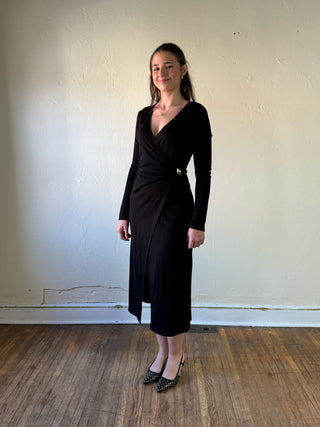 Black surplice wrap long sleeve midi dress by SUNDAY EDITION BY LE LIS, shown on a model.