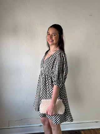 MOD REF Aileen Gingham Babydoll Dress in DMIN, featuring a flowing silhouette and classic gingham pattern, displayed on a hanger.