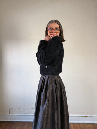 Black fuzzy pearl button cropped cardigan by FLYING TOMATO, featuring a cozy knit texture and pearl button details.