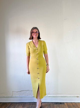 SKIES ARE BLUE Golden Hour Sweater Dress, cozy knit dress with a relaxed fit, displayed on a hanger against a neutral background.