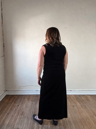 Black sleeveless velvet midi dress with ruched details, extended size from STEVIE JANE, shown on a model.