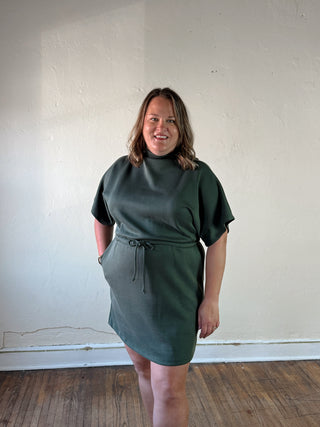 SUNDAY EDITION BY LE LIS mock neck mini dress with drawstring waist, stylish and fitted design, shown in black fabric.