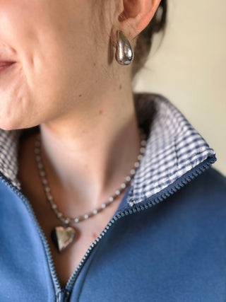 FLÂNERIE BY MAIQ Colette 18K gold non-tarnish large huggie droplet earring, silver finish, close-up view.