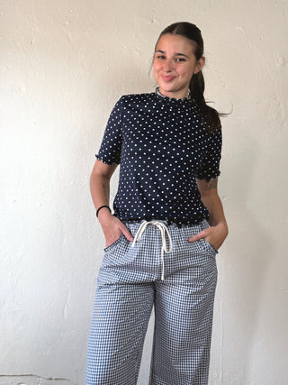 Black Dotty Mock Neck Top by SUNDAY EDITION BY LE LIS, featuring a fitted mock neck and dotted pattern.