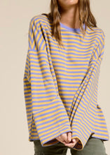 Load image into Gallery viewer, Person wearing a yellow and blue striped sweater against a beige background
