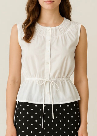 White sleeveless top with a drawstring waist worn by a person on a beige background