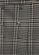 Load image into Gallery viewer, A plaid skirt with buttons displayed on a person&#39;s waist level.
