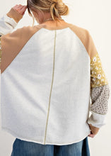 Load image into Gallery viewer, Woman wearing a patchwork sleeve pullover with a plain background
