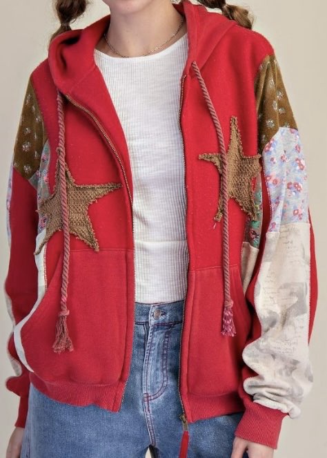 Red hoodie with star designs and floral patterns on a neutral background