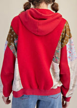 Load image into Gallery viewer, Red hoodie with floral and patchwork patterns on a neutral background
