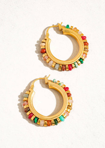 Gold hoop earrings with colorful beads on a white background