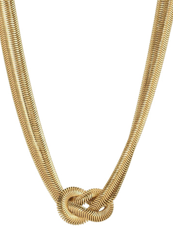 Gold necklace with a knot design on a white background