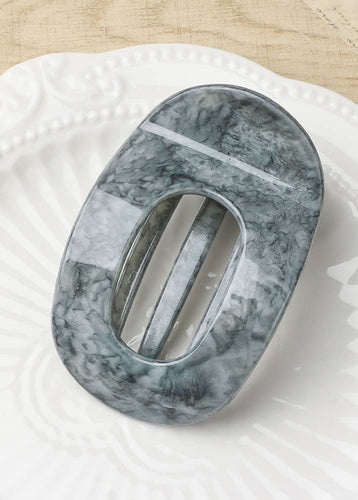 Marble-patterned soap dish on a textured surface