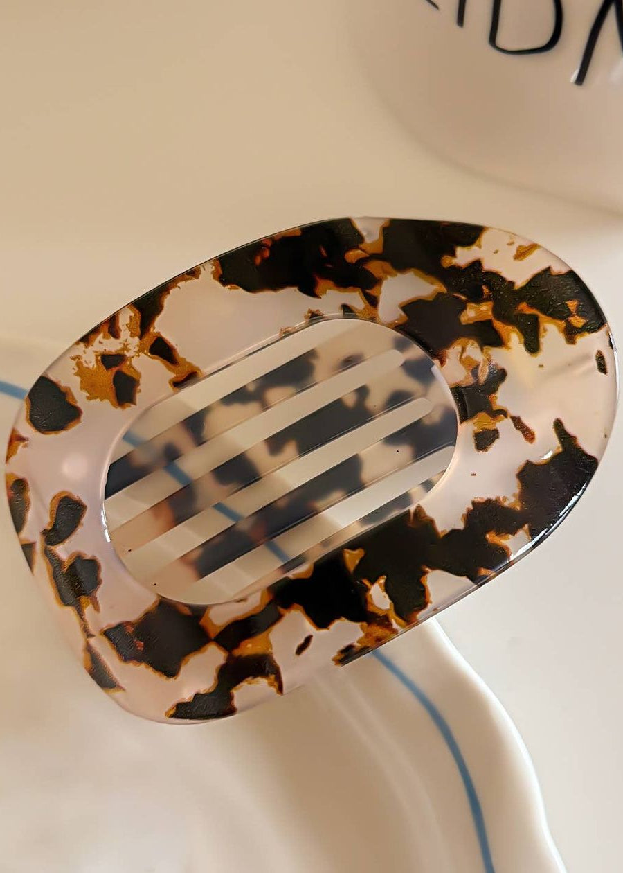 Tortoiseshell patterned hair clip on a white background